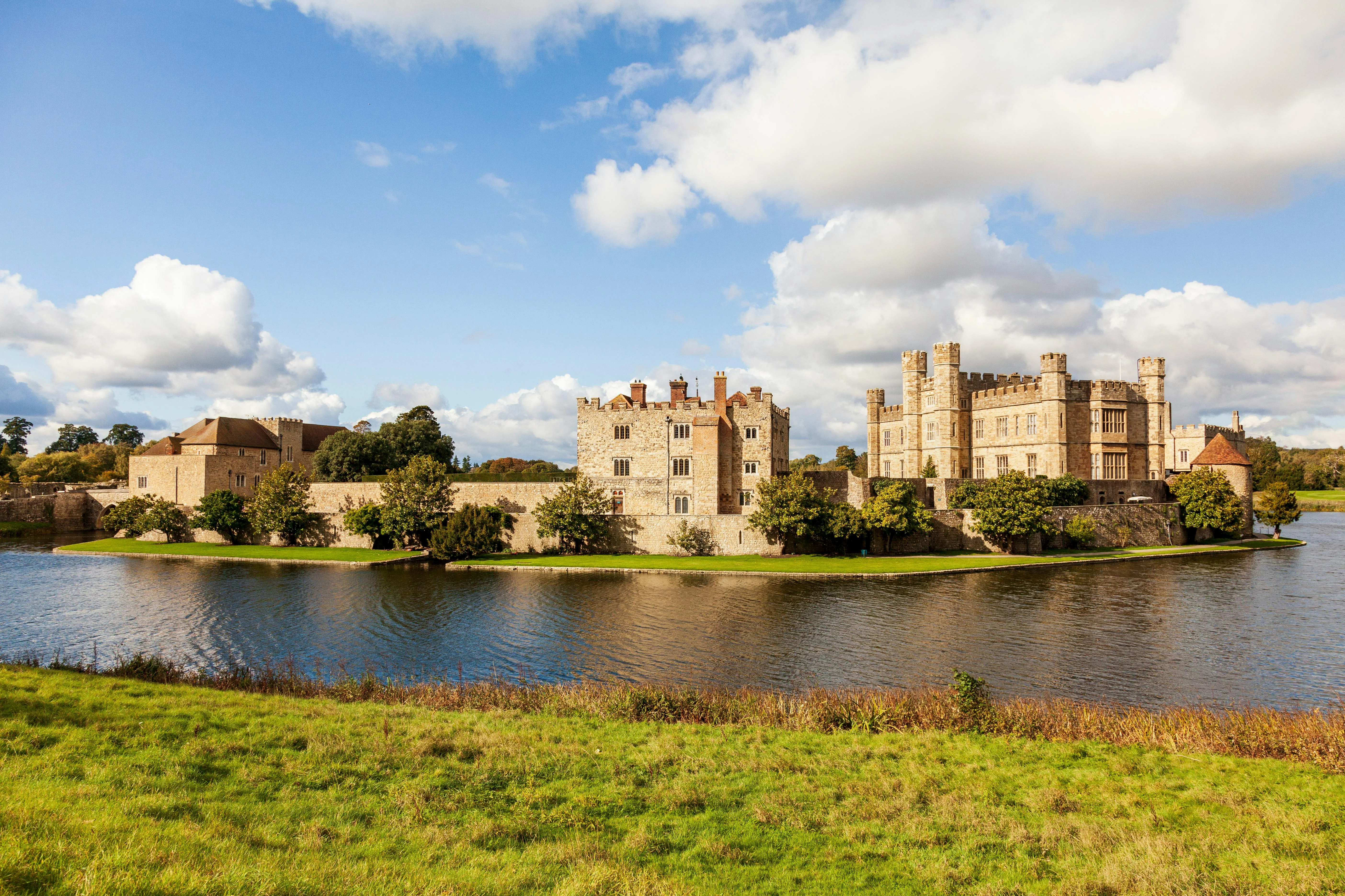 Leeds Castle in Kent reflected in its surrounding moat on a clear day
