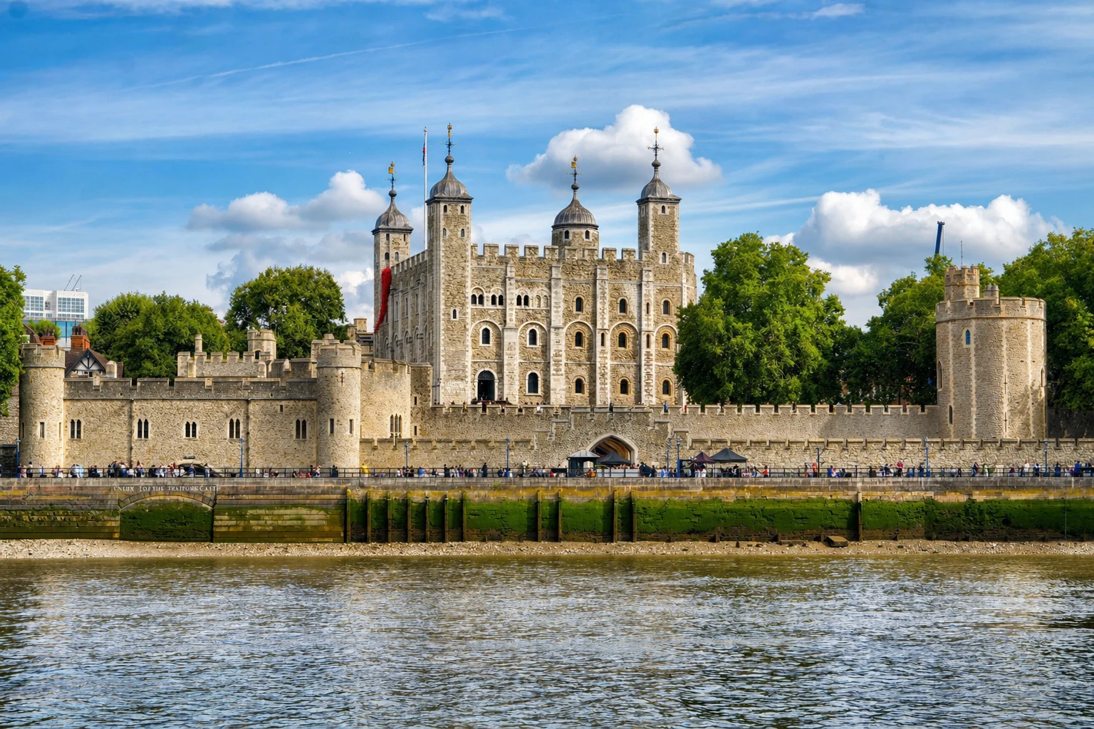 The Tower of London -- the White Tower and outer walls viewed from the Thames riverbank